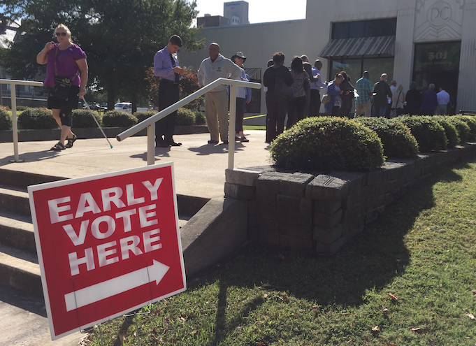 Voters line up outside the Pulaski County Regional Building at noon Monday to cast an early ballot. 