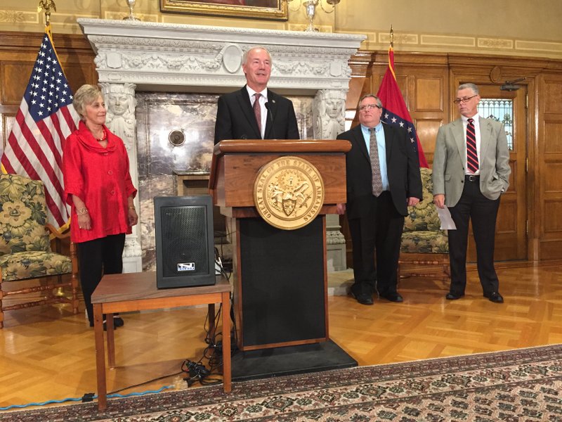 Governor Asa Hutchinson stands with War Memorial Stadium commission members and state officials to announce his proposed plan for the structure. 