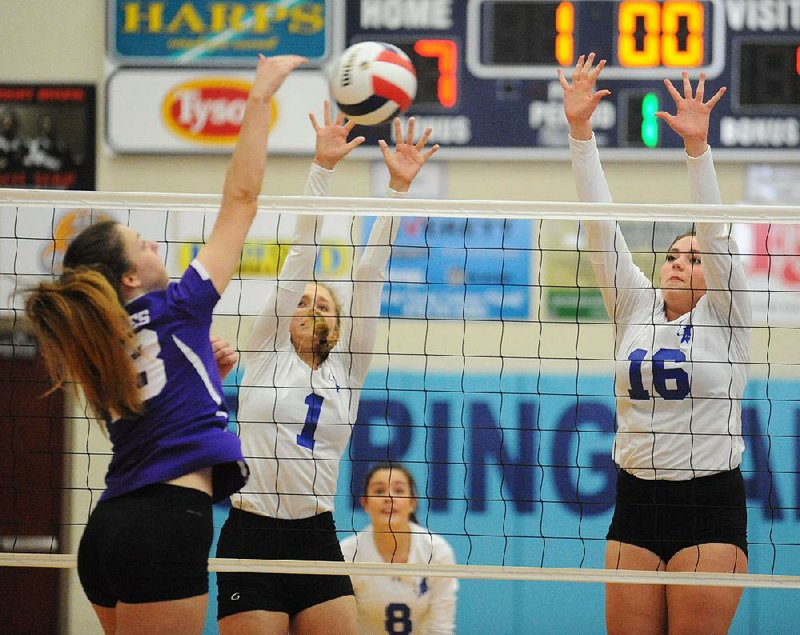 Madison Sherrill (1) and Alex Parish (16) of Rogers block a shot by Anna Cobb of Mount St. Mary in the Lady Mounties 25-16, 25-20, 22-25, 25-17 victory at the Class 7A state volleyball tournament in Springdale.