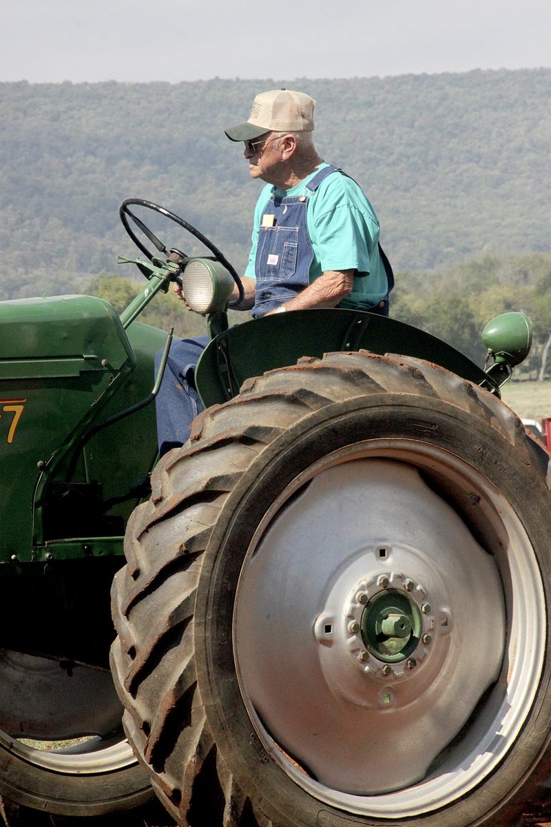 LYNN KUTTER ENTERPRISE-LEADER Don Carte of Lincoln drives an Oliver Row Crop 77 in the parade of power at the Tractor Show and Pull on Nolen Farm in Morrow.