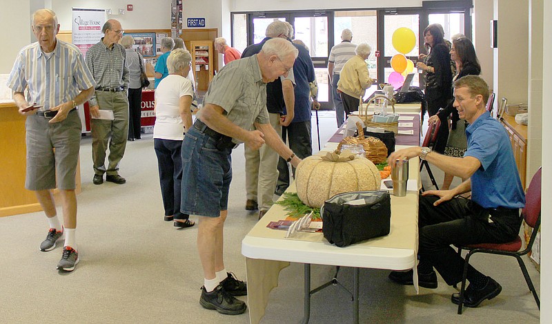 Keith Bryant/The Weekly Vista Senior Safety Academy attendees speak with vendors during a break between speakers.