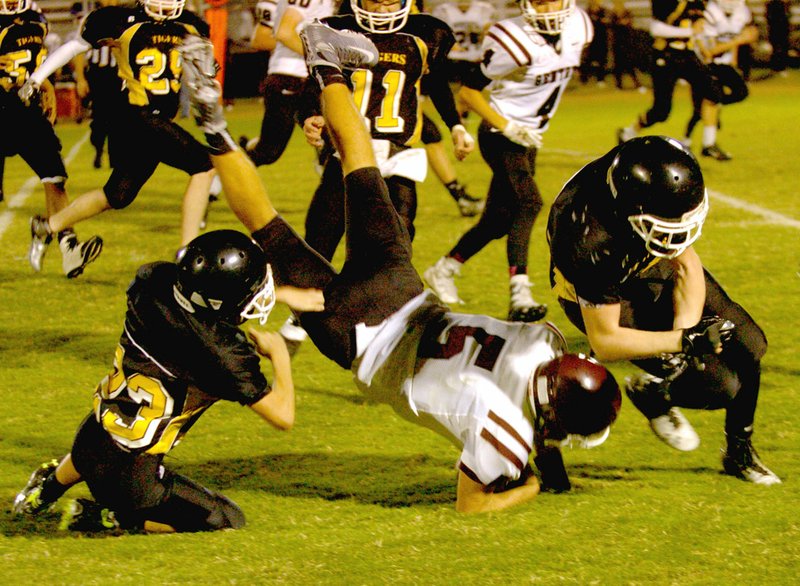 MARK HUMPHREY ENTERPRISE-LEADER Prairie Grove&#8217;s Cody Kruse upends Gentry quarterback Brandon Atwood, forcing a fumble that was recovered by Prairie Grove&#8217;s Jadin Higgins. Officials ruled no fumble and Gentry marched on to score. The junior Pioneers won 32-24 Thursday.