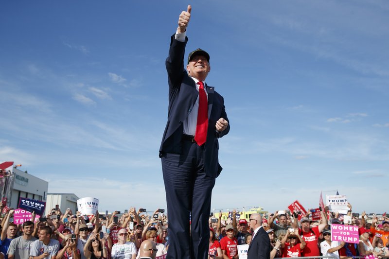 Republican presidential candidate Donald Trump gestures as he arrives to speak to a campaign rally, Tuesday, Oct. 25, 2016, in Sanford, Fla. (AP Photo/ Evan Vucci)