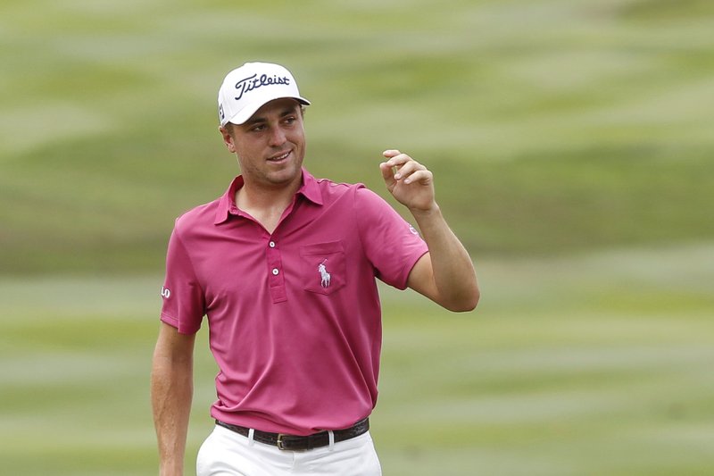 The Associated Press WINNING FORM: Justin Thomas acknowledges the crowd after putting on the first green during the final round of the CIMB Classic golf tournament at Tournament Players Club (TPC) in Kuala Lumpur, Malaysia on Sunday. Thomas shot a 64 on the final round to win the tournament by three strokes.