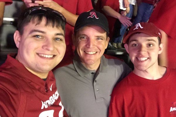 Cameron Storm, left, Russell Hatridge, center, and Nick Hatridge pose for a picture during Arkansas’ game against Ole Miss. 