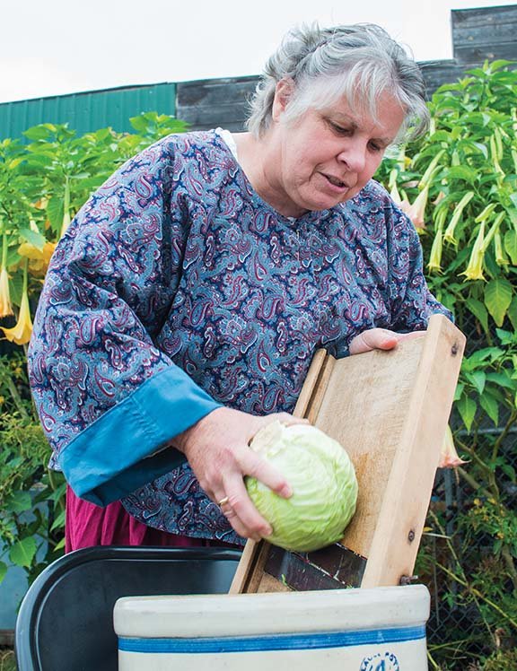 Shirley Pratt of the Happy Valley neighborhood near Centerville will demonstrate making sauerkraut at Saturday’s fall celebration in Centerville. She uses a crock jar and shredder that belonged to her mother to make the sauerkraut.