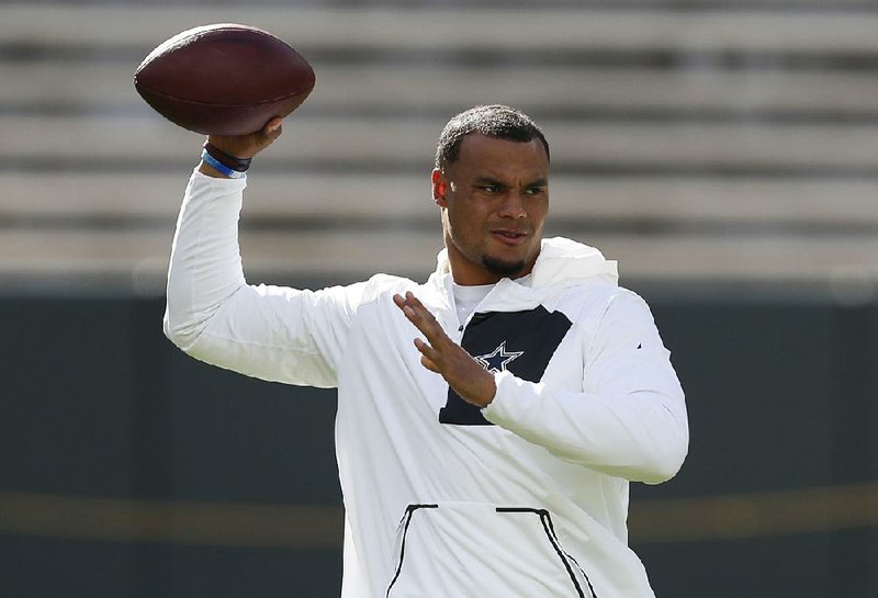 Dallas Cowboys' Dak Prescott warms up before an NFL football game against the Green Bay Packers Sunday, Oct. 16, 2016, in Green Bay, Wis. 