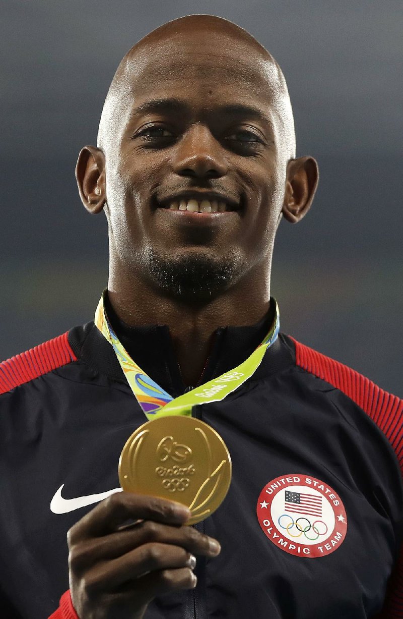 United States' Jeff Henderson shows off his gold medal during the men's long jump medals ceremony in the athletics competitions of the 2016 Summer Olympics at the Olympic stadium in Rio de Janeiro, Brazil, Sunday, Aug. 14, 2016.