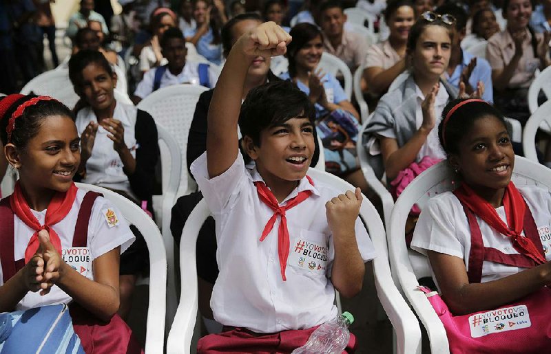 Cuban students cheer the U.N. vote results Wednesday during a University of Havana watch party that was organized by Cuban officials. It featured live state news coverage broadcast on a big-screen television.