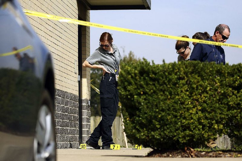 Little Rock detectives and crime scene specialists search for evidence outside Econo Lodge Inn & Suites at 9101 Mabelvale Pike after a man was shot in the leg Wednesday afternoon.