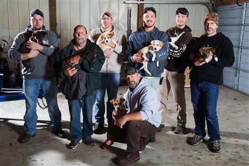 In this Wednesday, Oct. 26, 2016, photo, from left, Jake Rowe holding Knox, Joe Gruber holding Bear, Alex Manchester holding Rosie, Doug Craddock with Annie, Mitchel Craddock holding Brimmie, Brent Witters holding Finn and Dexter Jennings holding Gunner pose for a photo in Vicksburg, Mich. 