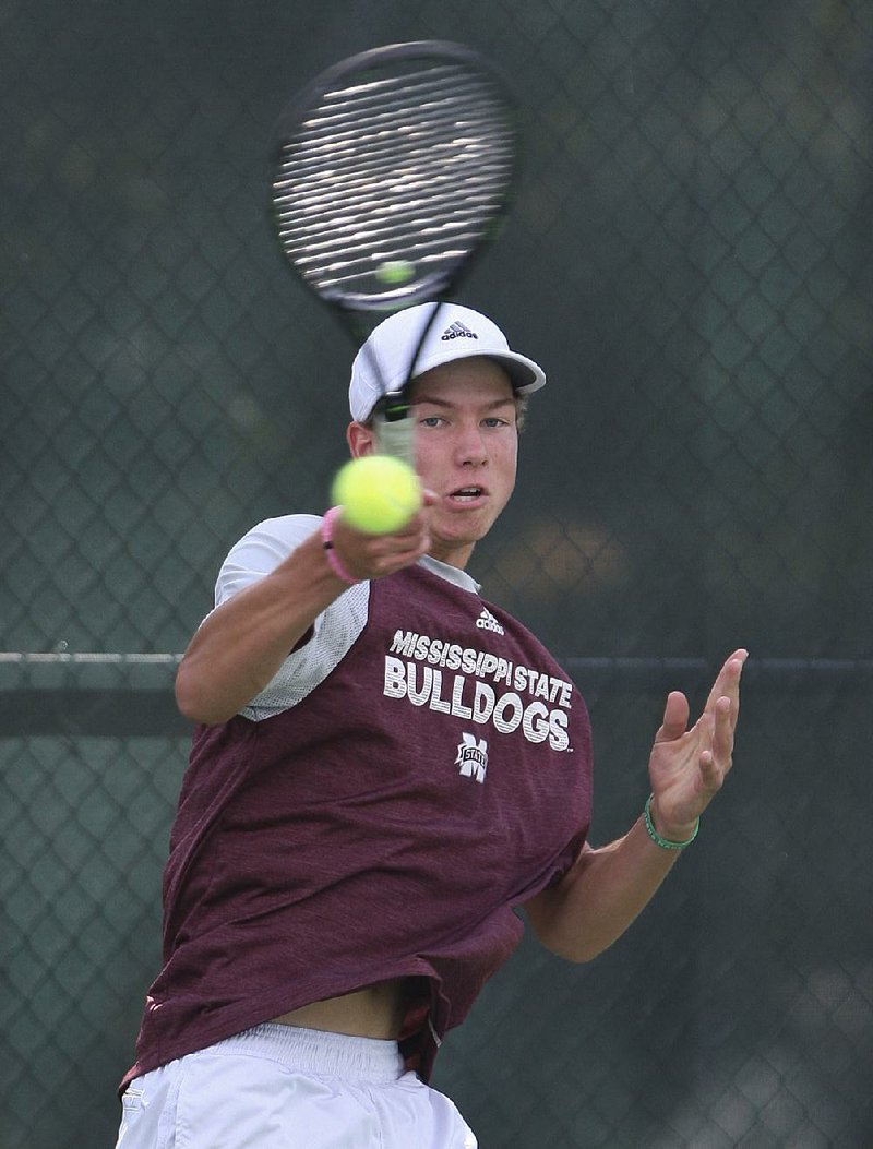 Pulaski Academy’s Hunter Harrison returns a shot during his match against Little Rock Catholic’s Parker Stearns on Thursday at the overall tennis tournament at Burns Park in North Little Rock. Harrison won 6-4, 6-3.