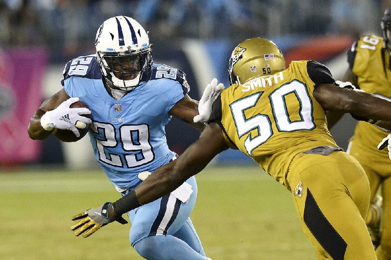 Tennessee Titans running back DeMarco Murray (29) tries to get past Jacksonville Jaguars linebacker Telvin Smith during the first half of an Thursday’s game in Nashville, Tenn. Murray finished with 123 yards and 1 touchdown on 21 carries as the Titans won 36-22.