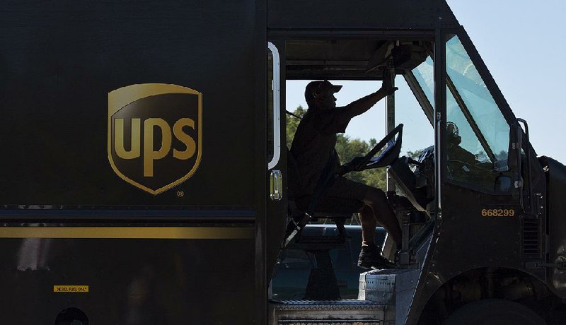 A UPS driver enters a company warehouse in Birmingham, Ala., in this file photo. The package delivery company on Thursday reported a quarterly profi t of $1.27 billion.
