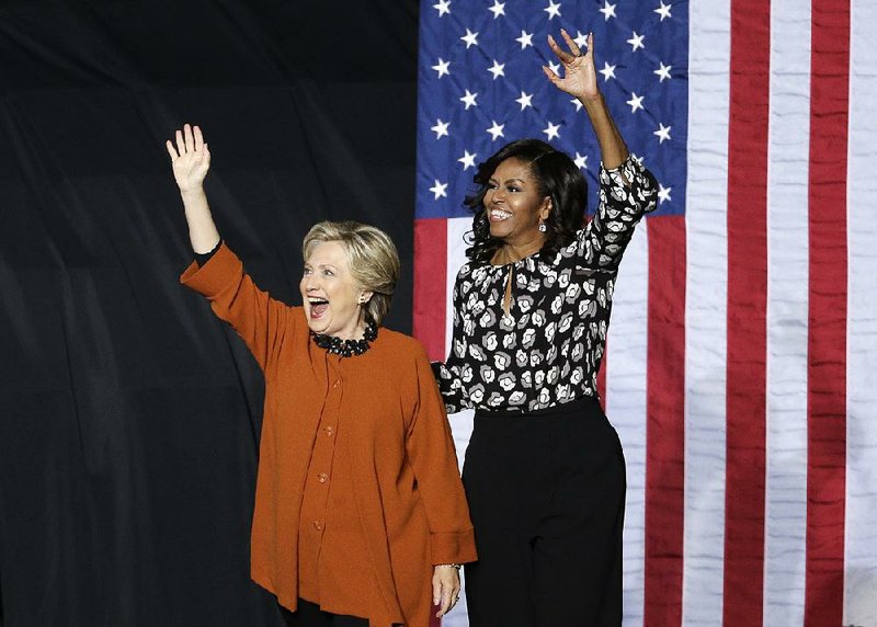 Democratic presidential candidate Hillary Clinton and first lady Michelle Obama wave to supporters during a campaign rally Thursday in Winston-Salem, N.C.