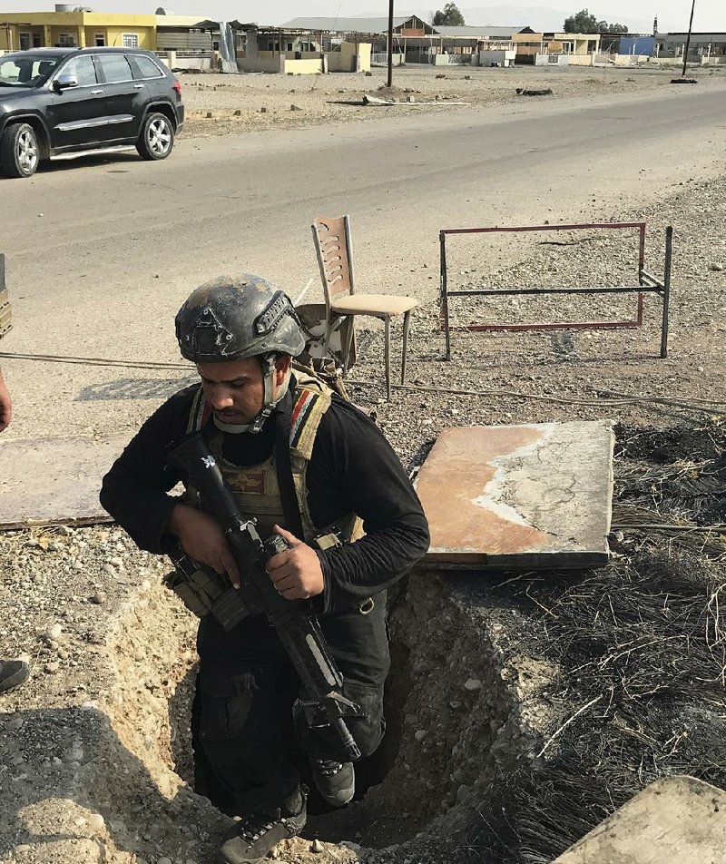 A soldier with Iraq’s elite counterterrorism force on Thursday inspects a tunnel dug by Islamic State militants in Bartella, Iraq.