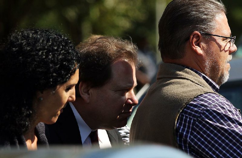 FILE — Ted Suhl, center, exits the federal courts building in Little Rock after being sentenced in a case involving the bribery of a state official.