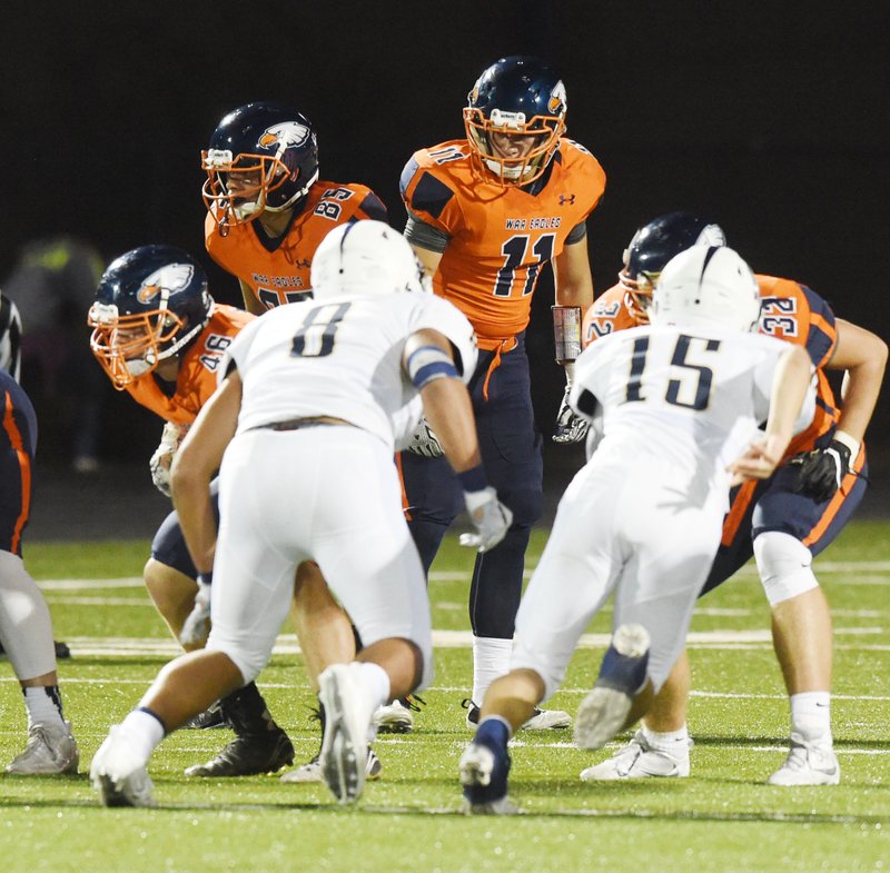 Heritage High School's Josh Palacios (11) and Roberto Palacios (85) prepare to block for the punter against Bentonville West on Oct. 21 at Heritage High School.