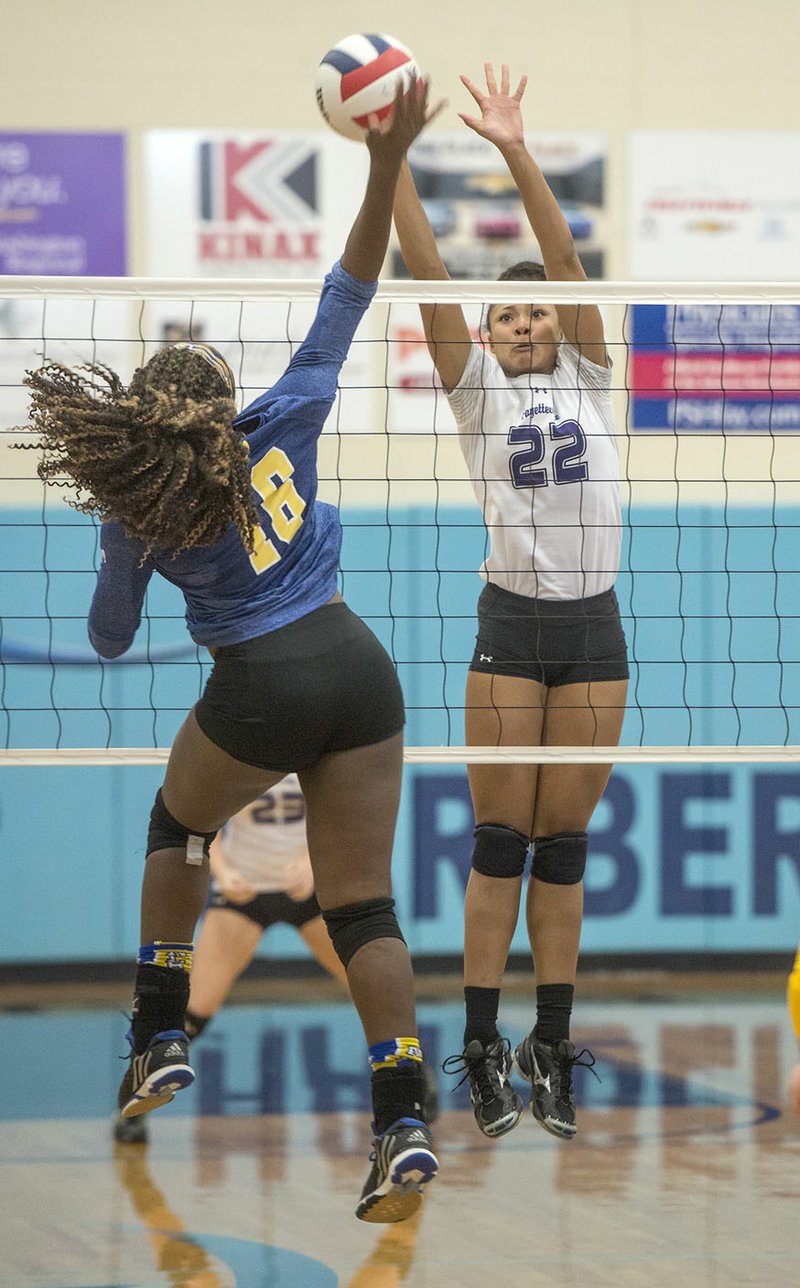 Lauren Holmes (22) of Fayetteville defends a shot from Jada Curtis of North Little Rock on Thursday during the 7A state tournament at Wildcat Arena in Springdale.