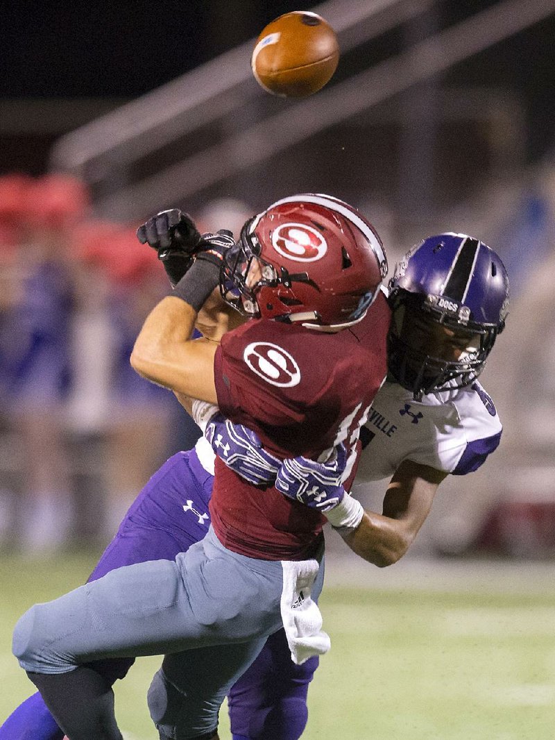 Fayetteville’s Trey Coulter breaks up a pass intended for Springdale’s Alex Thompson in Fayetteville’s 56-7 victory Friday night in Springdale.