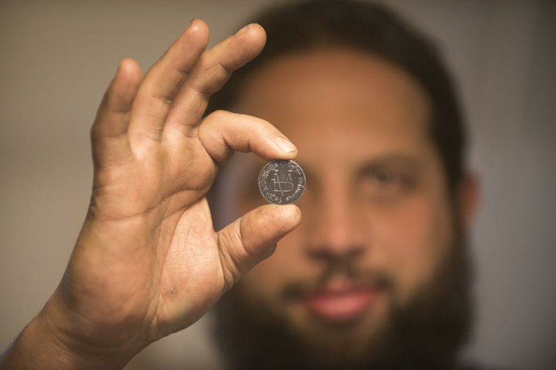 Woody Maringer, operations manager at Shire Post Mint, holds a Faceless Man coin. In Game of Thrones, the coin is used as a calling card of sorts. 