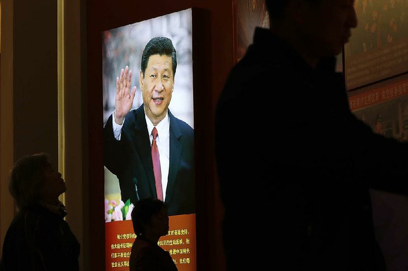 Visitors walk by an image of Chinese President Xi Jinping on display at the military museum in Beijing. Under Xi’s leadership the country has been cracking down on unapproved religious groups, including a small group of Jews
in Kaifeng.