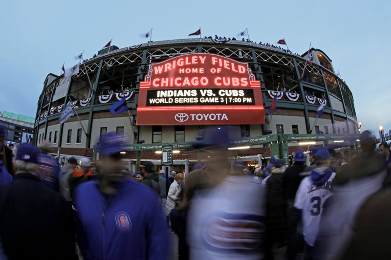 Fans arrive to Wrigley Field for Game 3 of the Major League Baseball World Series between the Cleveland Indians and the Chicago Cubs Friday, Oct. 28, 2016, in Chicago. (AP Photo/Charlie Riedel)