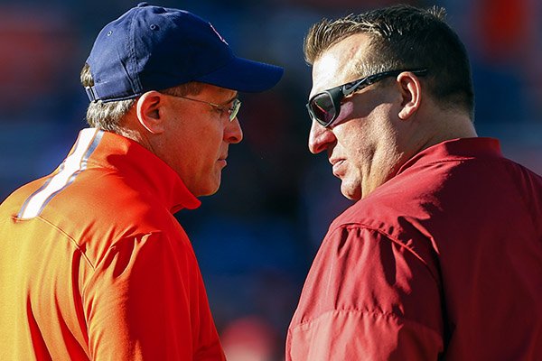 Auburn head coach Gus Malzahn, left, talks with Arkansas head coach Bret Bielema before an NCAA college football game, Saturday, Oct. 22, 2016, in Auburn, Ala. (AP Photo/Butch Dill)

