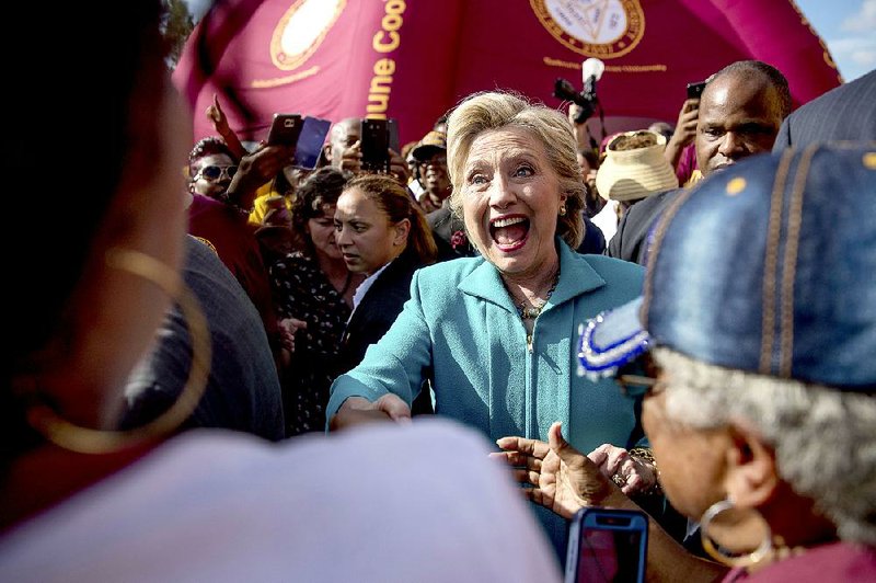 Democratic presidential candidate Hillary Clinton greets people Saturday at a homecoming tailgate party before a football game between Bethune-Cookman University and Delaware State in Daytona Beach, Fla.