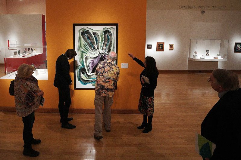 Rana Edgar with the Arkansas Arts Center gestures toward a piece of art while discussing it recently as part of the Crystal Bridges Museum of American Art travel program.