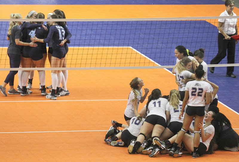 Fayetteville players (right) pile together to celebrate their Class 7A championship while Har-Ber players huddle on the court Saturday in Hot Springs.