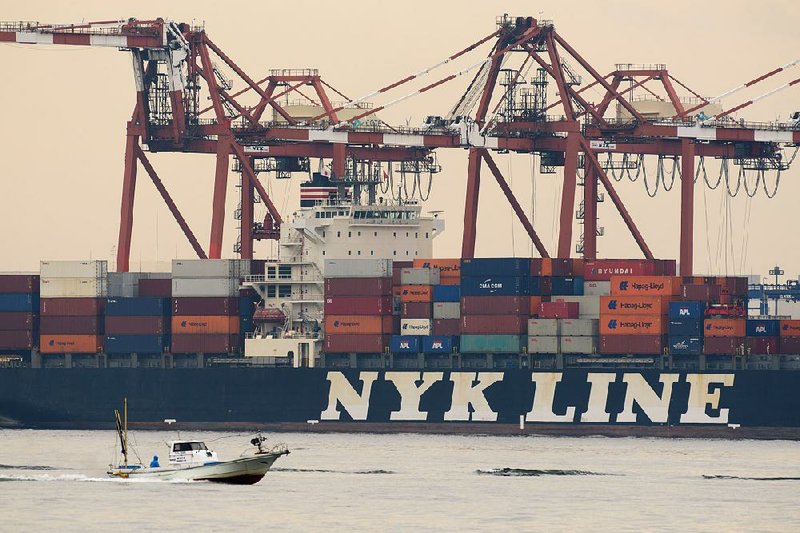 A Nippon Yusen KK container ship is moored at the shipping terminal in Tokyo on Monday. Nippon is merging its container operations with two other Japanese shipping companies to create one of the world’s largest shippers.