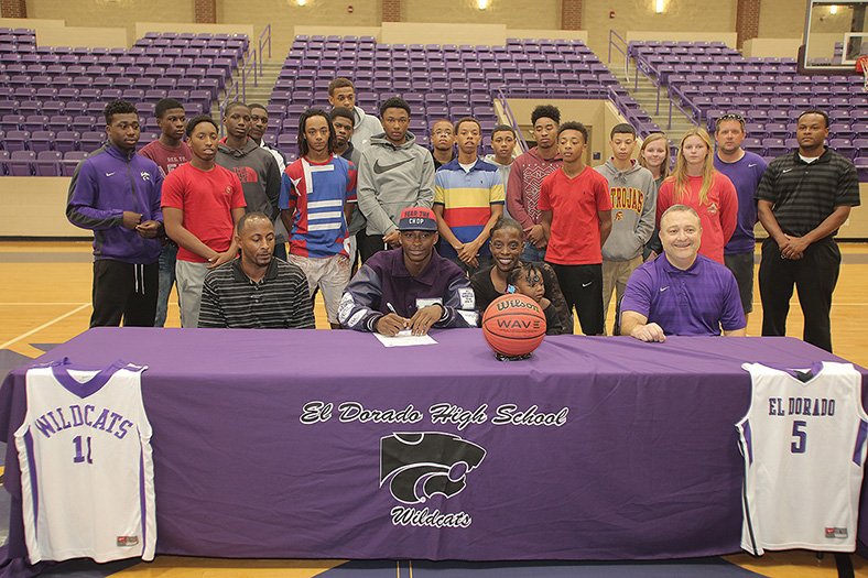 Michael Orrell/News-Times El Dorado basketball player Czar Perry signs his letter-of-intent to play for Itawamba Community College in front of family, friends and coaches in the Wildcat Arena on Tuesday.
