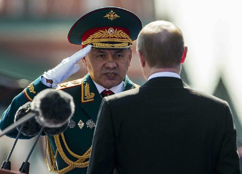 Russian Defense Minister Sergei Shoigu, shown saluting President Vladimir Putin in Moscow’s Red Square in May, said Tuesday that Russia is continuing its moratorium on airstrikes in the Syrian city of Aleppo. Putin rejected a Russian military request to resume the strikes.