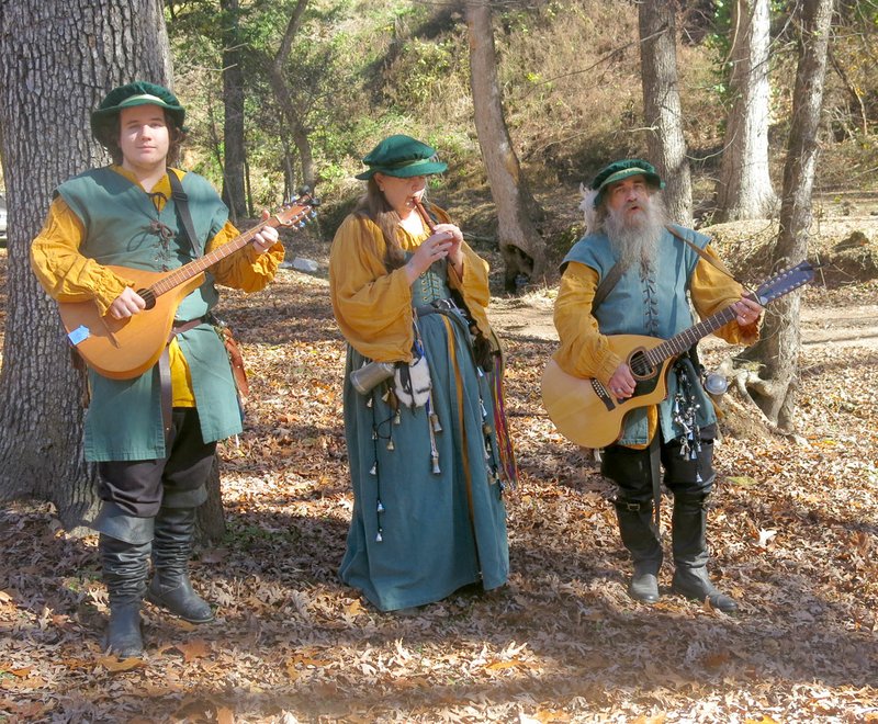 Photo by Susan Holland Jingly Bits, a trio of minstrels who perform English and Irish folk tunes, greeted guests near the bridge in Old Town Park at the 2015 Renaissance festival. The popular trio is slated to return for this year&#8217;s festival, from 10 a.m. to 5 p.m. Saturday, and will stroll through the park entertaining fans with their selection of vintage songs.