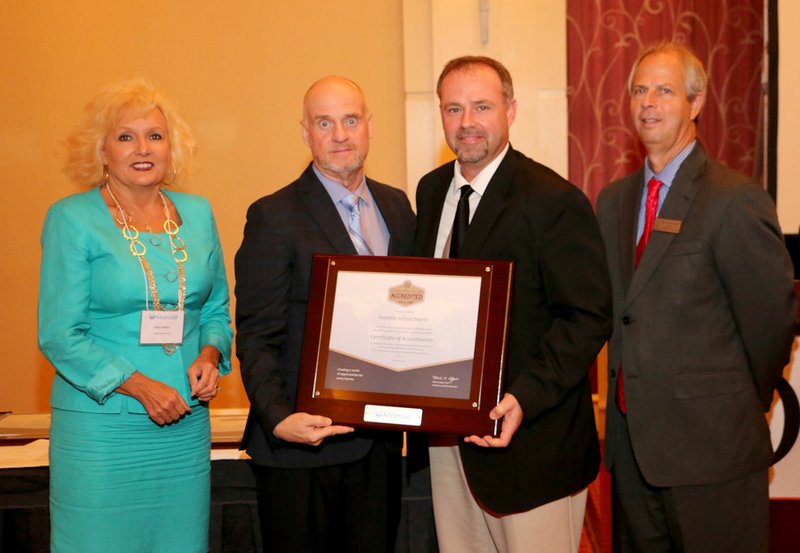 Photo by Lifetouch Photography Gravette school district received a certificate of accreditation at the AdvancED Arkansas Conference in Little Rock on Oct. 18. On hand for the presentation were Holly Cothren (left), AdvancED Arkansas State Council chair and superintendent of Dierks School District; David Hurst, AdvancED deputy chief operations officer; Zane Vanderpool, principal of Glenn Duffy Elementary School in Gravette; and Kenny Pennington, AdvancED Arkansas state director.