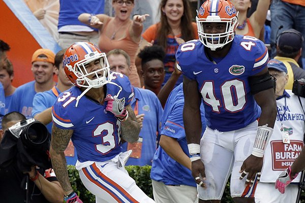 Florida defensive back Teez Tabor (31) celebrates his interception for a 39-yard touchdown against Missouri with teammate linebacker Jarrad Davis (40) during the first half of an NCAA college football game, Saturday, Oct. 15, 2016, in Gainesville, Fla. (AP Photo/John Raoux)