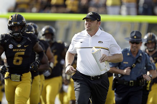 Missouri head coach Barry Odom jogs out with his team before the start of an NCAA college football game against Kentucky Saturday, Oct. 29, 2016, in Columbia, Mo. (AP Photo/Jeff Roberson)
