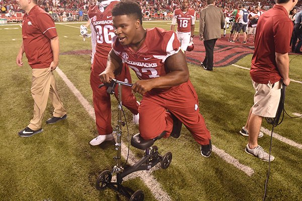 Injured Arkansas linebacker Dre Greenlaw leaves the field on a walking scooter following a game against Ole Miss on Saturday, Oct. 15, 2016, in Fayetteville. 