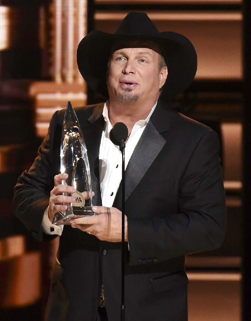 Garth Brooks accepts the award for entertainer of the year at the 50th annual CMA Awards at the Bridgestone Arena on Wednesday, Nov. 2, 2016, in Nashville, Tenn. 