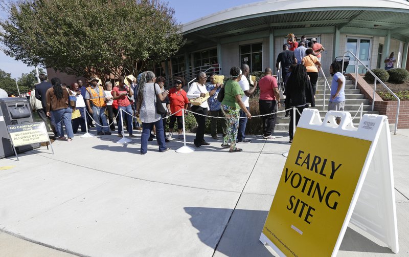  In this Oct. 20, 2016 file photo, voters line up during early voting at Chavis Community Center in Raleigh, N.C. 