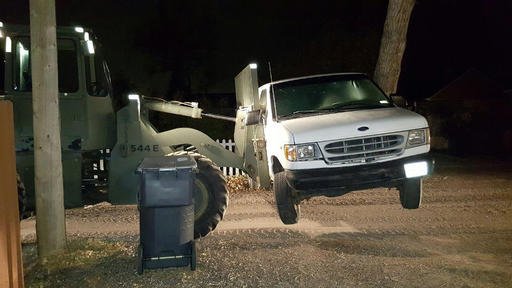 This Sunday, Oct. 30, 2016, photo taken by the Cheyenne Police Department shows a front-end loader with forklift that was used by a Cheyenne, Wyo., woman to move her van in front of her driveway.