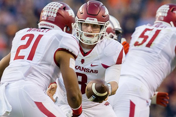 Arkansas quarterback Austin Allen looks to hand off to running back Devwah Whaley on Saturday, Oct. 22, 2016, against Auburn at Jordan-Hare Stadium in Auburn, Ala.