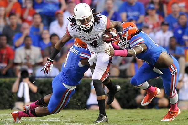 Arkansas receiver Keon Hatcher is tackled during a game against Florida on Saturday, Oct. 5, 2013, in Gainesville, Fla. 