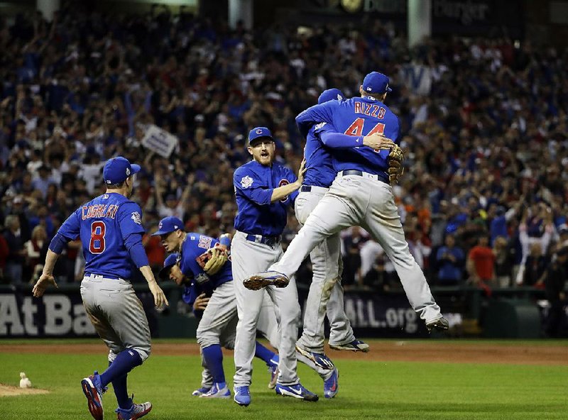 Chicago Cubs players Mike Montgomery (left), Kris Bryant (center) and Anthony Rizzo celebrate after the final out of Wednesday night’s 8-7 victory over the Cleveland Indians in Game 7 of the World Series. The victory gave the Cubs their first Series championship since 1908.
