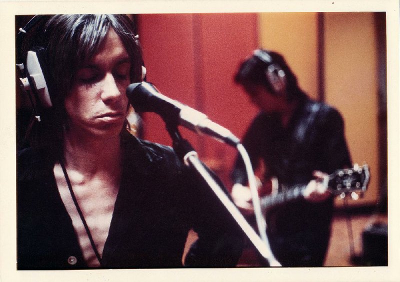 A young Iggy Pop records in a London studio with fellow Stooge James Williamson in the background.