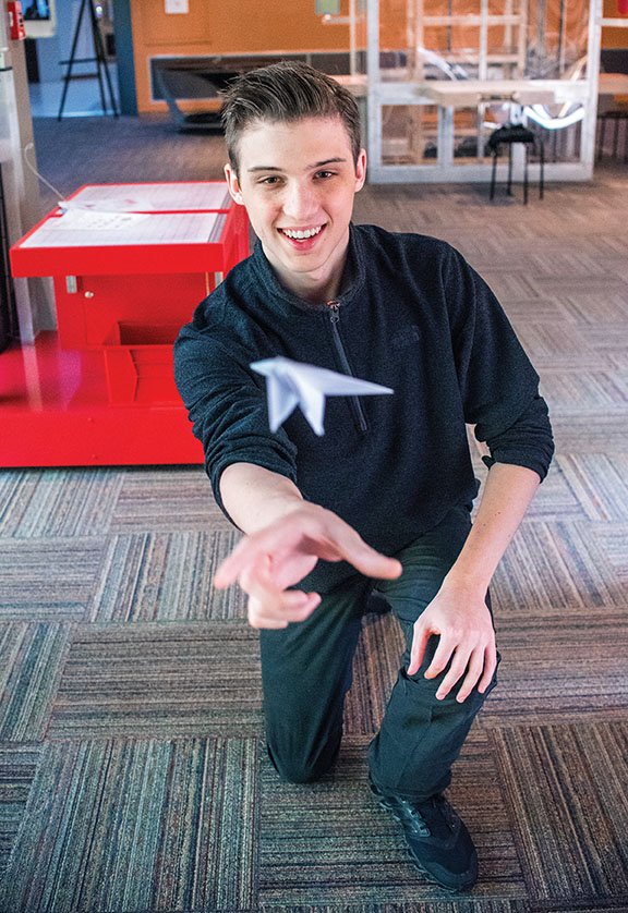 Kye Masino, founder of KYE-YAC International, flies a paper airplane that is part of the Imaginate exhibit at the Mid-America Science Museum in Hot Springs. KYE-YAC is the presenting sponsor of the special exhibit.