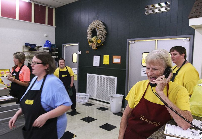 Betty McKim (right) takes a call-in order as other Honeycomb employees tend to customers. The Arkadelphia restaurant, which provides jobs to developmentally disabled people, is closing in December.