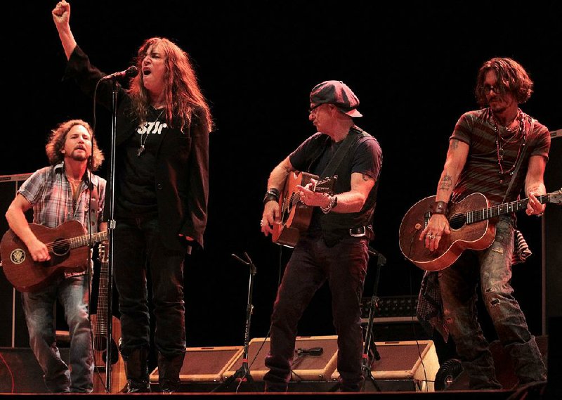 In 2010, a Voices for Justice concert at Robinson Center was put on by Arkansas Take Action, a group advocating for the overturning of the convictions of the West Memphis Three. Eddie Vedder (from left), Patti Smith, Bill Carter and Johnny Depp played the concert. 