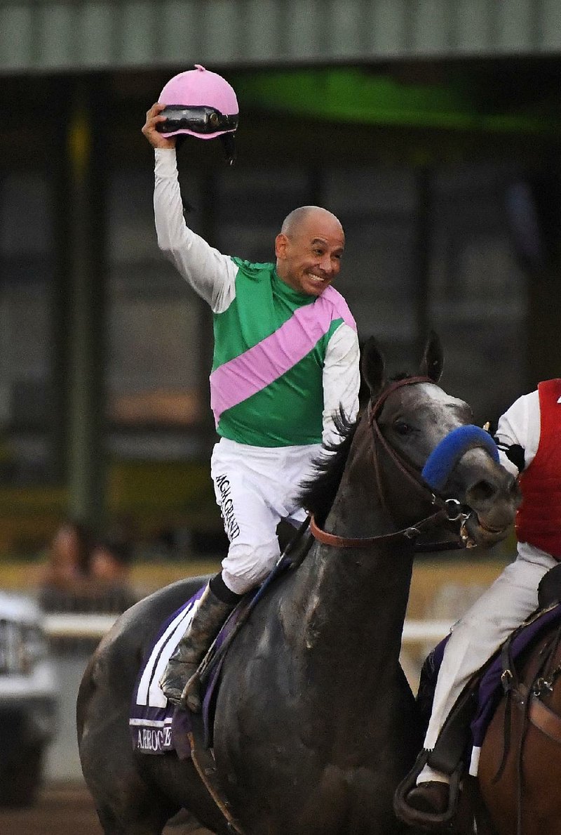 Jockey Mike Smith celebrates atop Arrogate after catching California Chrome to win the Breeders’ Cup Classic on Saturday at Santa Anita Park in Arcadia, Calif.